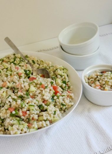 Large bowl and side dish of barley cucumber tomato and parsley