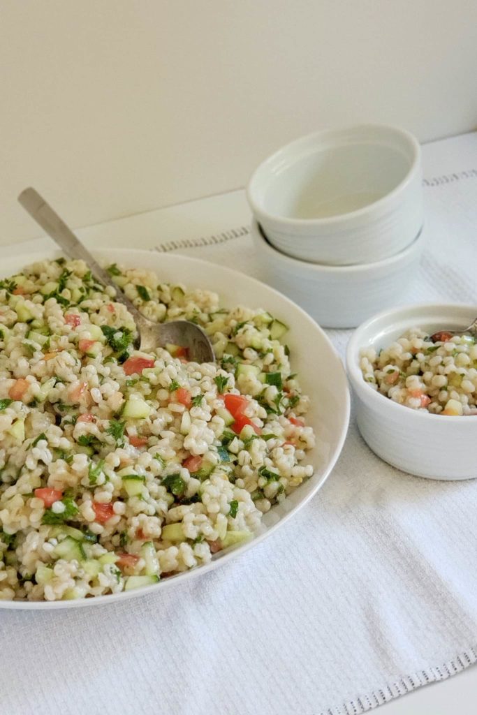 Large bowl and side dish of barley cucumber tomato and parsley