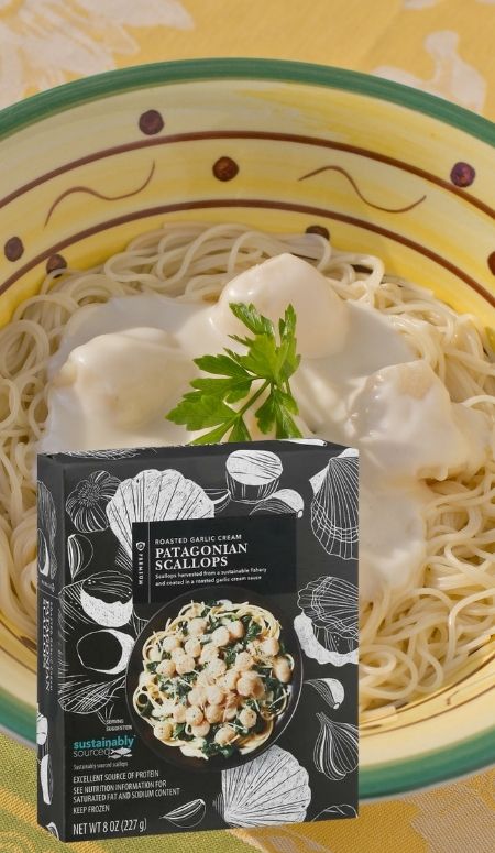 bowl of linguini and scallops with white cream sauce, overlay of box of publix patagonian scallops