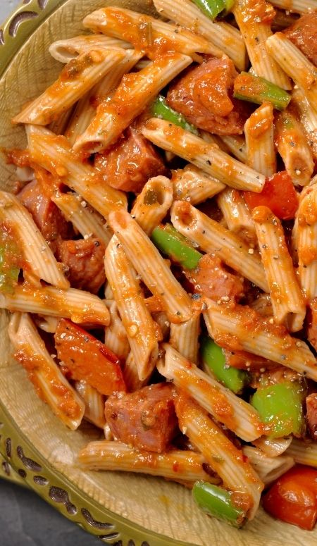penne pasta with diced peppers and sausage in a tomato sauce