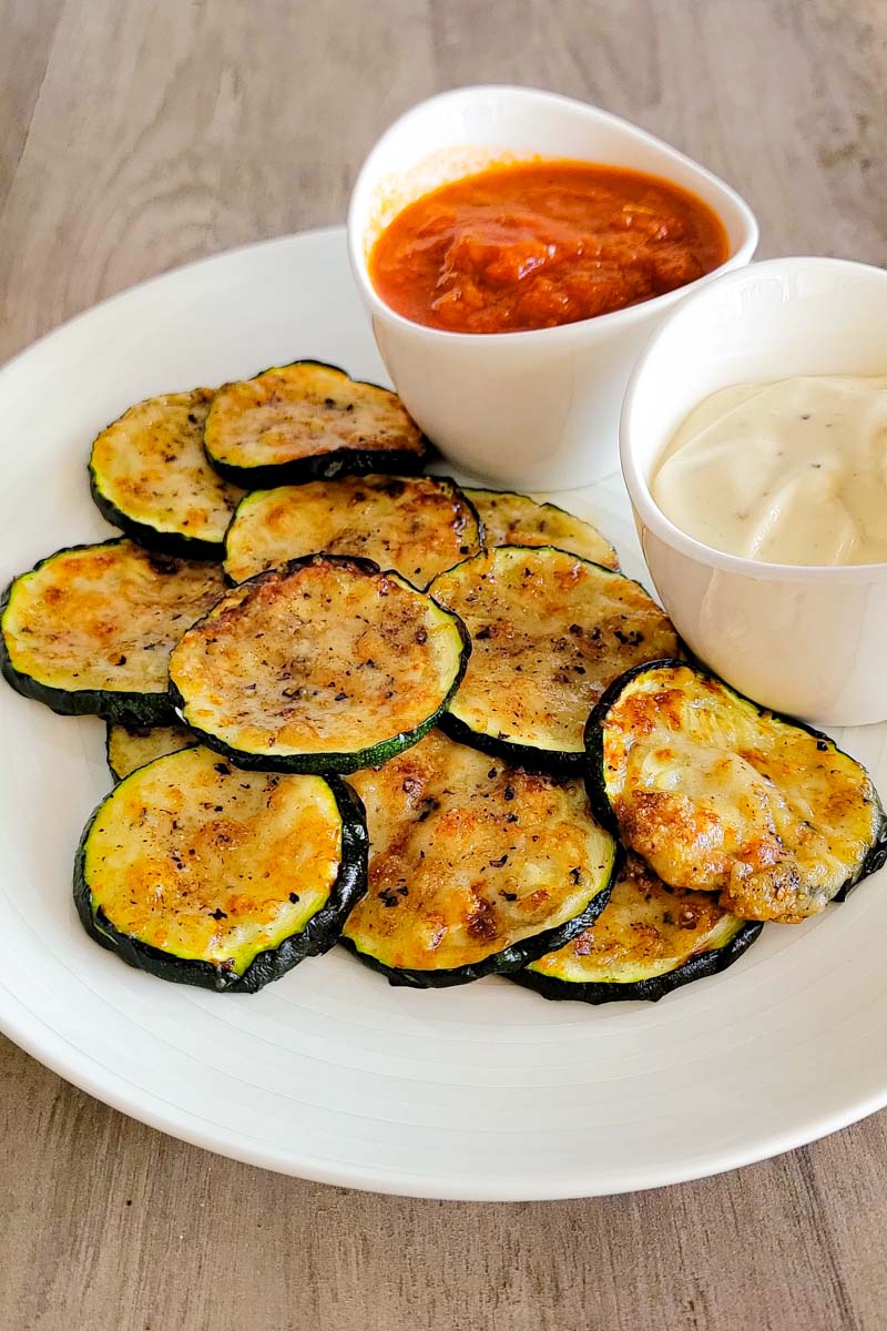 plated zucchini parmesan rounds with dipping sauces