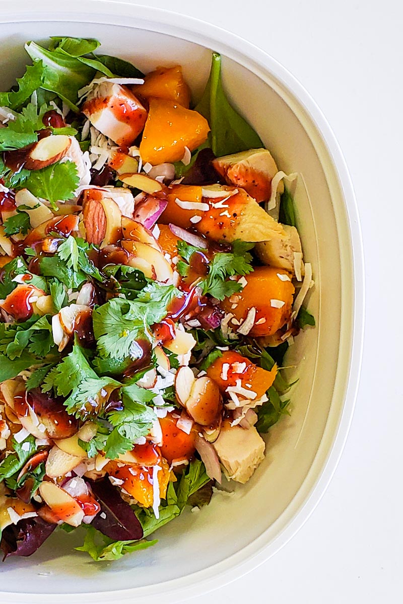 white bowl of assembled chicken mango salad