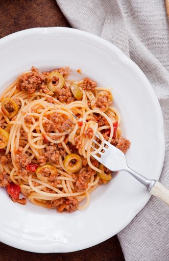 bowl of spaghetti with meat sauce with a fork.